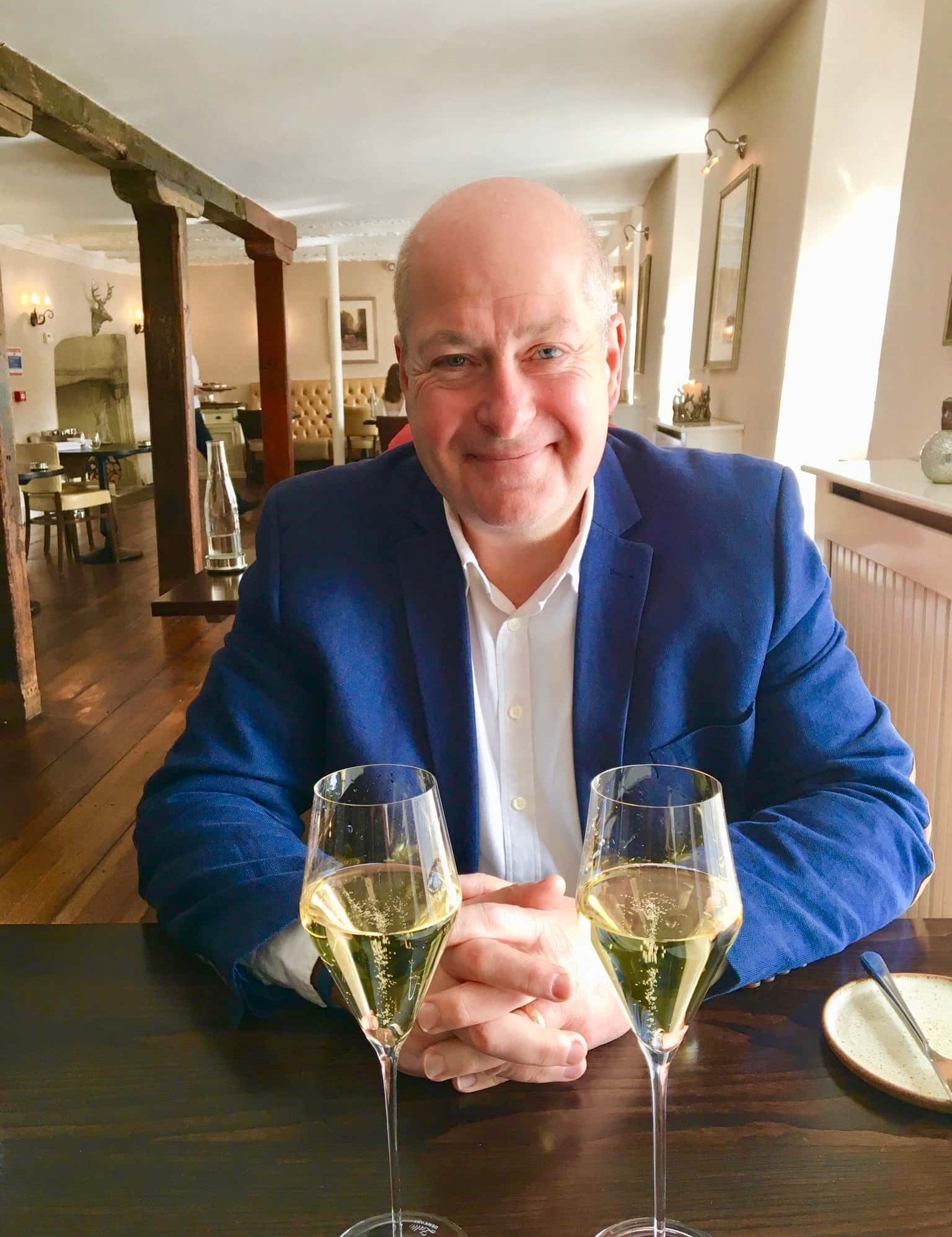 Mike Lawton wine lover reviewer at restaurant with 2 glasses of champagne