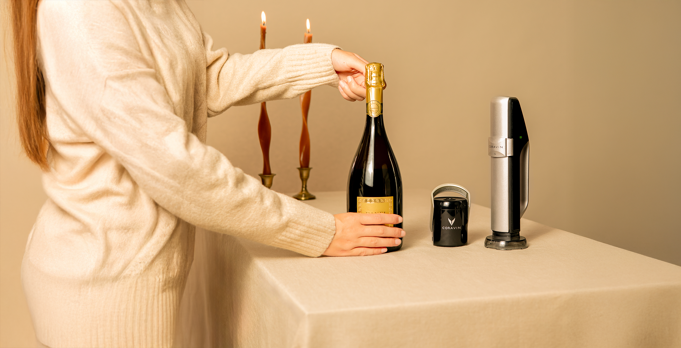 types of champagne guide with coravin: woman holding champagne wearing cream, against cream background.