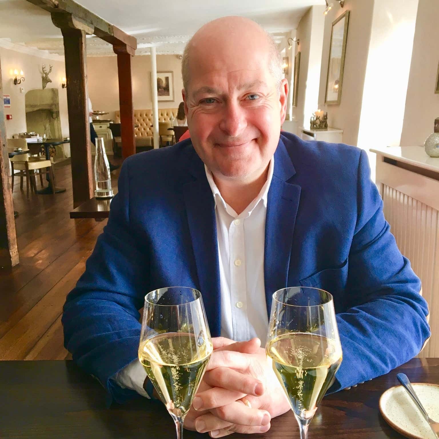 Mike Lawton wine lover reviewer at restaurant with 2 glasses of champagne