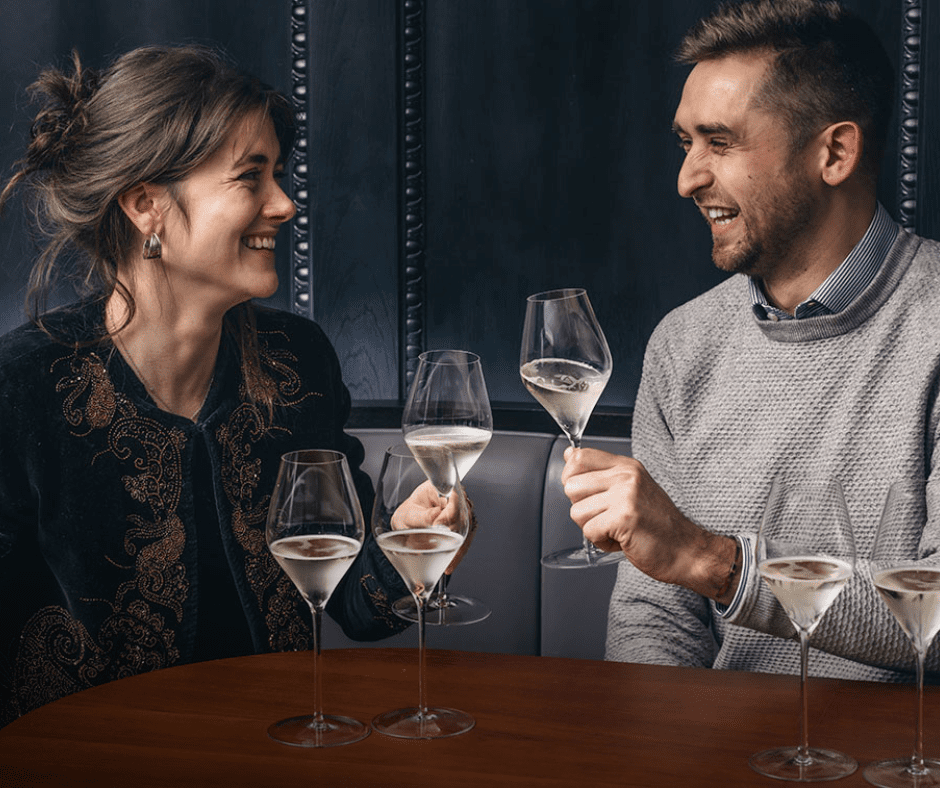 Two people enjoying glasses of wine together