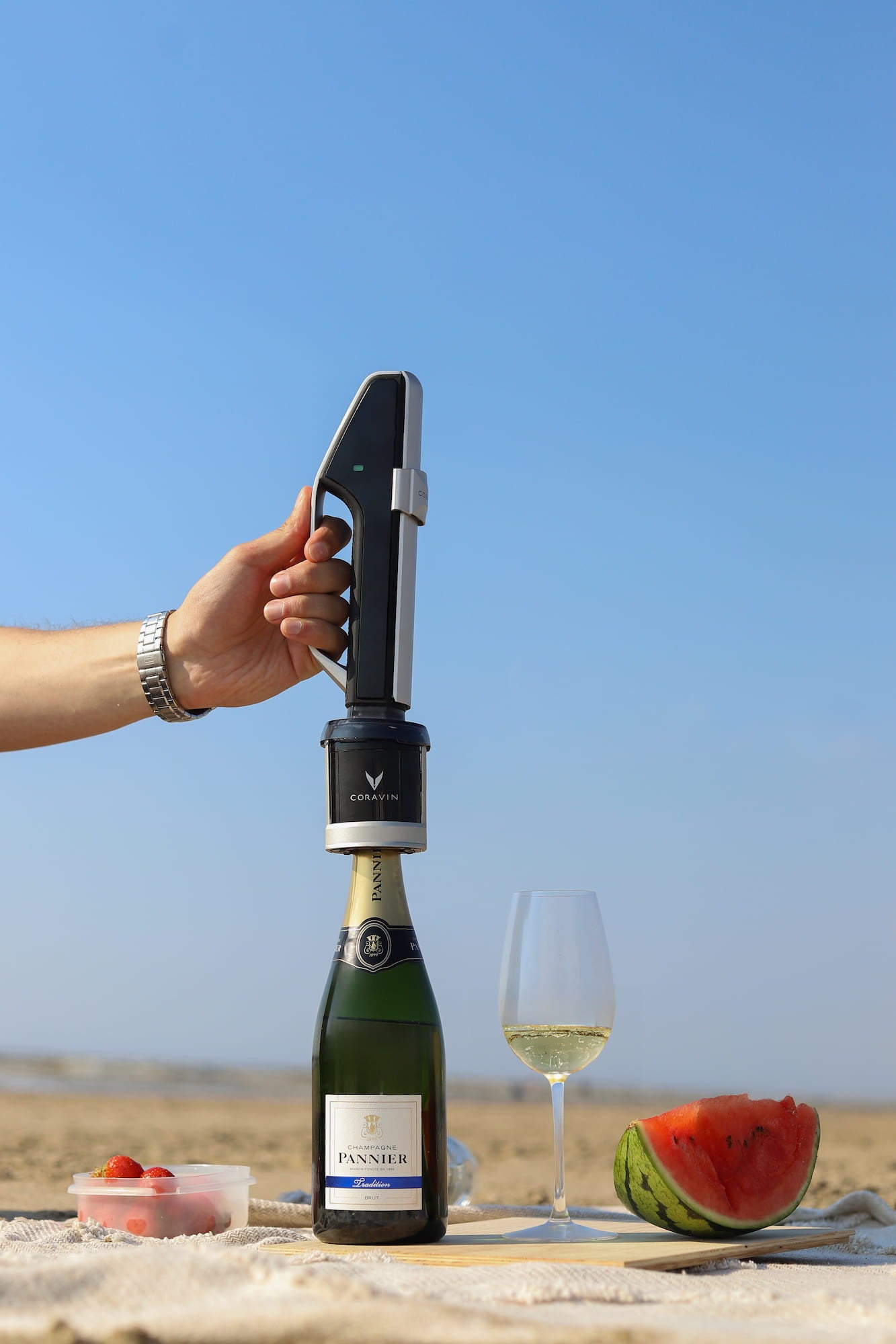 Sparkling wine bottle with a Coravin Sparkling Stopper on a picnic